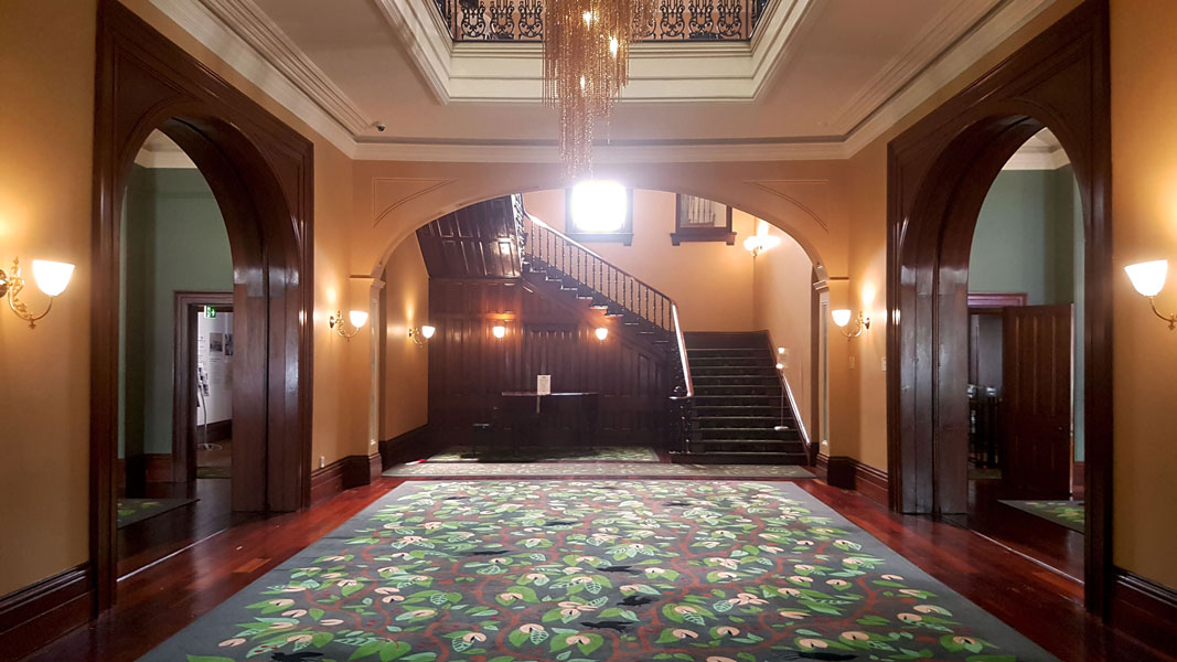 Old Government House interior view showing the main staircase and the area for the augmented reality (AR) app experience. 