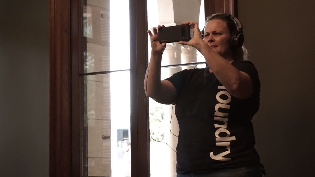 A person testing the augmented reality (AR) experience at Old Government House.