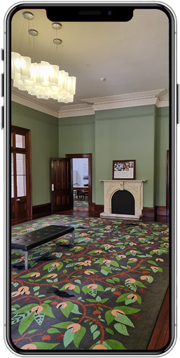 The Drawing room in Old Government House Brisbane, showing a tree inspired carpet, fireplace and bench.