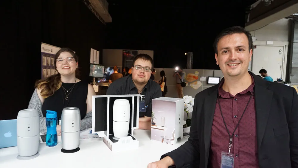 AIWA team members with the prototype in a showcase context.