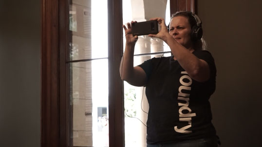 Visitor using the Skullduggery AR prototype inside Old Government House.